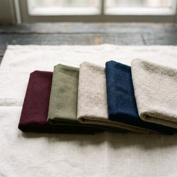 Five folded fabric swatches in a row