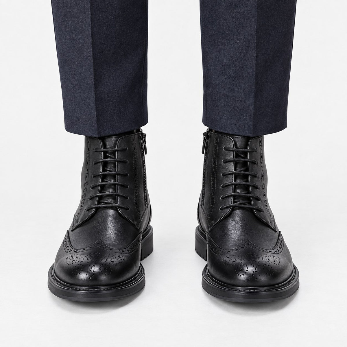 Leather wingtip boots with side zips
